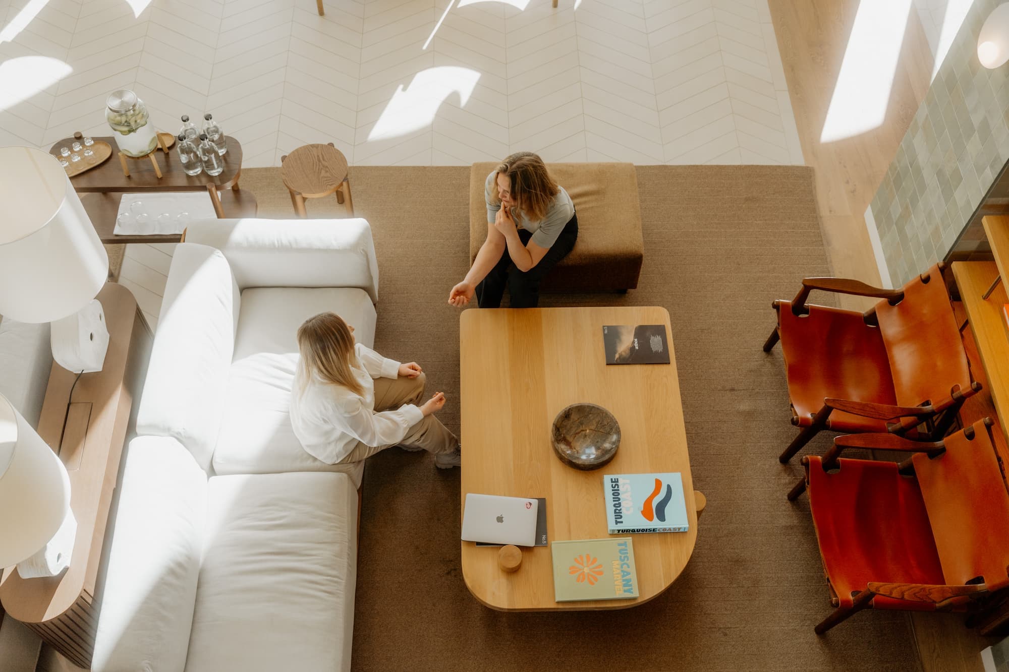 A modern office setting with a hiring manager and candidate having a discussion, symbolizing the intersection of traditional hiring practices and AI technology